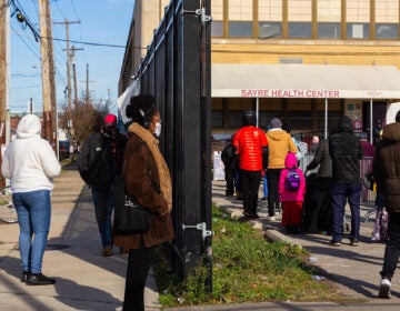 People stand in line outside Sayre Health Center for COVID testing a week before Thanksgiving in West Philadelphia. (Kimberly Paynter/WHYY)