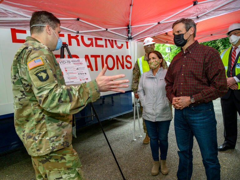 Tennessee Gov. Bill Lee, right, tours a temporary hospital site in April with his wife Maria Lee.