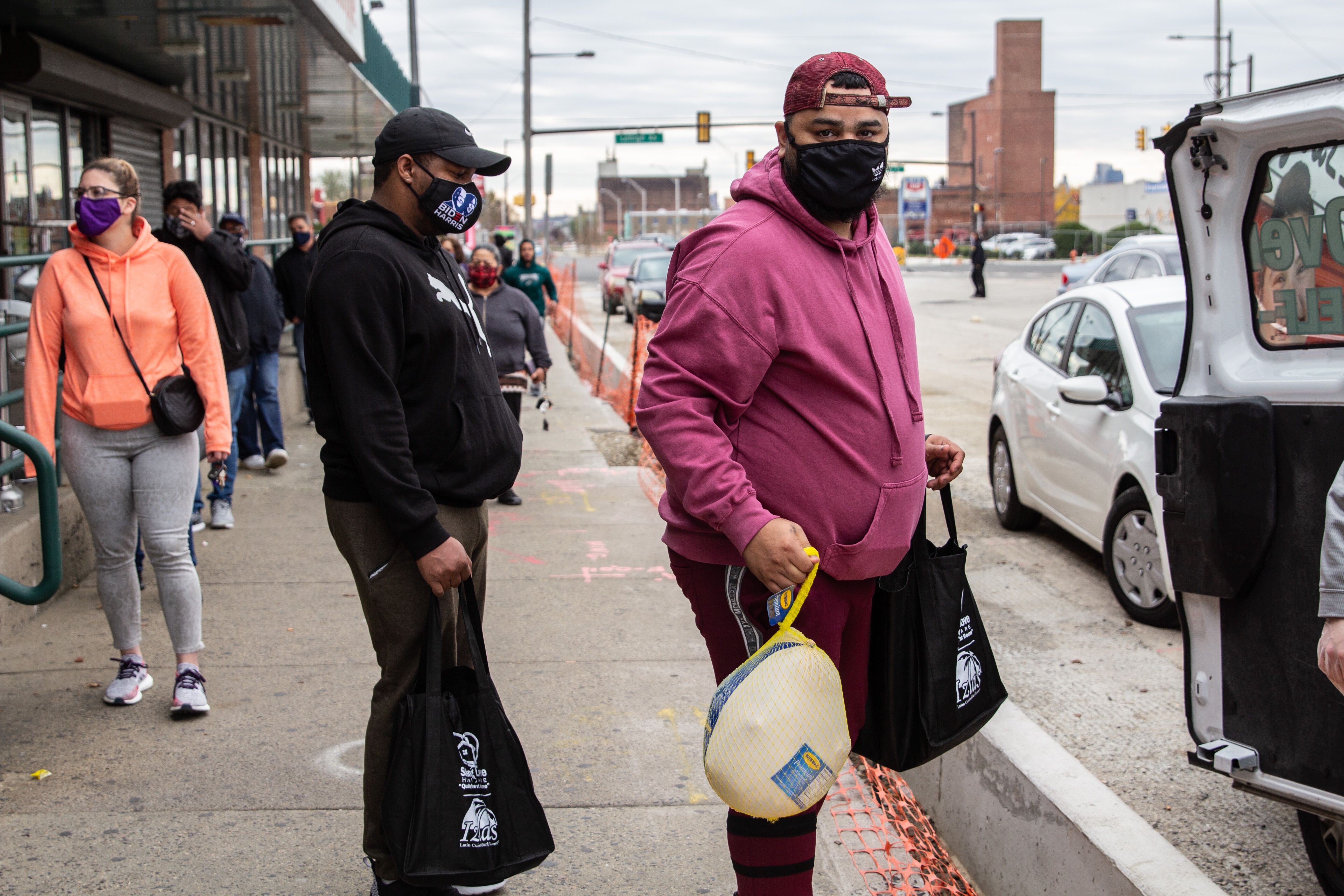 Kensington resident Alex Pagan waits in line for a free Thanksgiving turkey for his family.