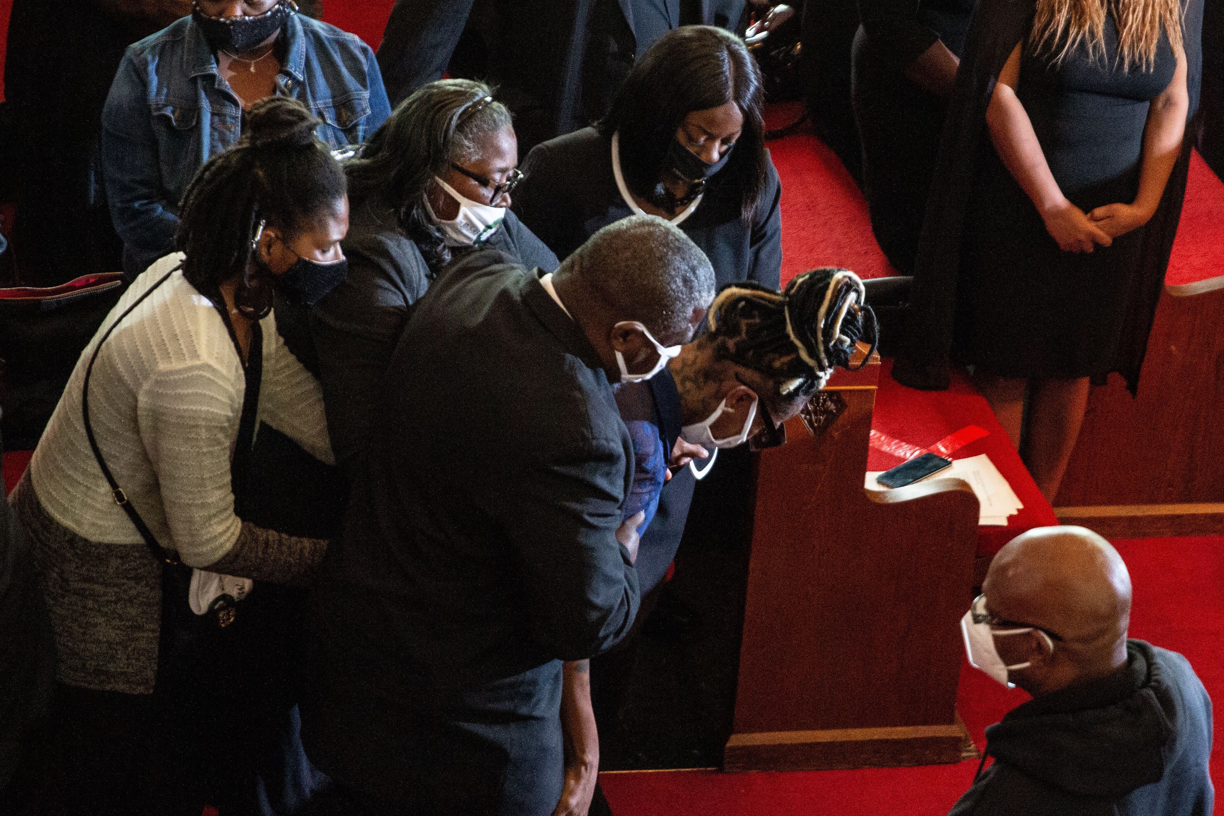 Dominique Wallace collapses at her husband's funeral in Philadelphia