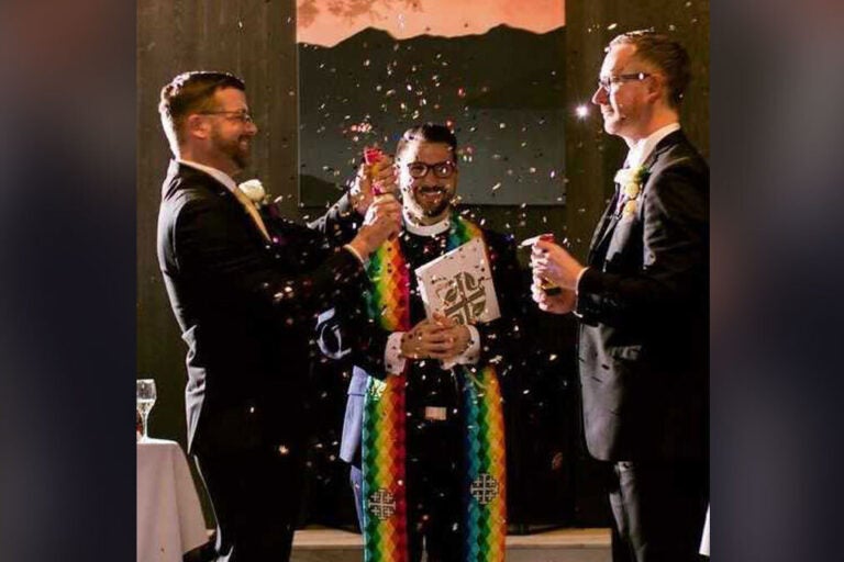 Rev. Fritz Fowler (center) marries Ted Sayland (left) and Rusty McCarty (right) in 2018. (Courtesy of Abigail Townsend Photography)
