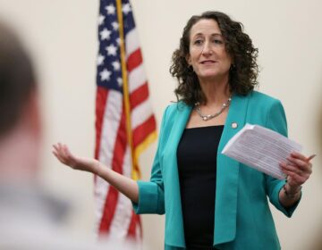 Kathy Boockvar gestures while holding a piece of paper