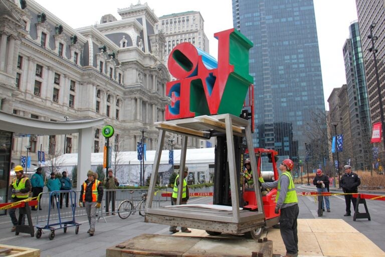 Workmen raise the LOVE statue off its pedestal in Dilworth Park in February 2017