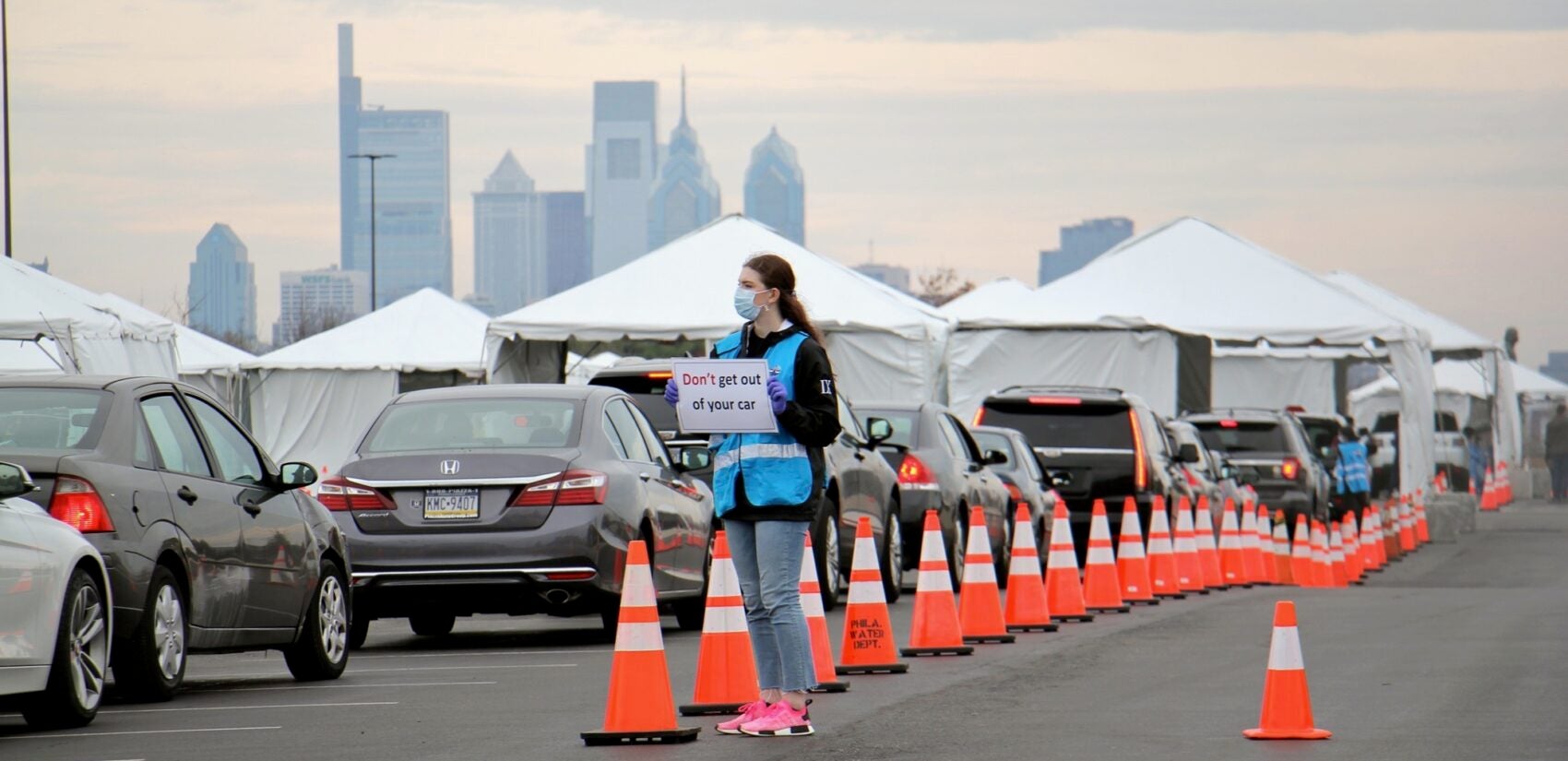 Cars line up at a drive-through coronavirus testing station in the parking lot at Citizens Bank Park. (Emma Lee/WHYY)