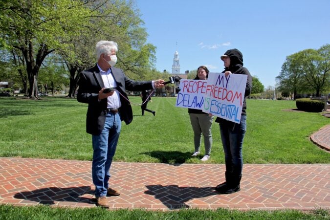 Cris Barrish interviews protesters outside Legislative Hall in Dover. (Emma Lee/WHYY)