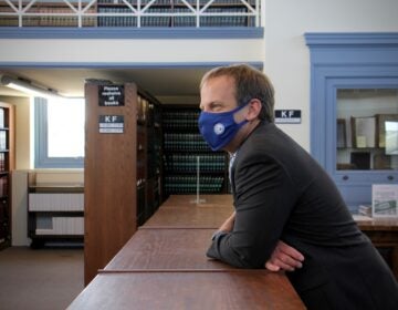 Chris Welsh, director of Delaware County's public defenders office, gathers with staff in the law library at the Delaware County Courthouse in Media, Pa. (Emma Lee/WHYY)