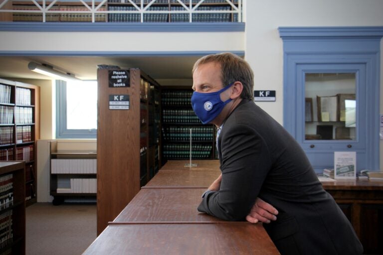 Chris Welsh, director of Delaware County's public defenders office, gathers with staff in the law library at the Delaware County Courthouse in Media, Pa. (Emma Lee/WHYY)