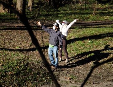 A couple celebrates the sunshine at Tacony Creek Park. (Emma Lee/WHYY)