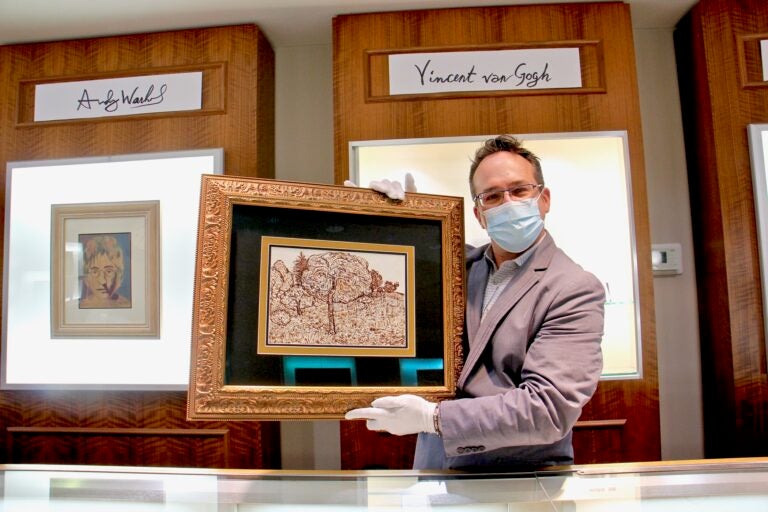 Jeweler Bob Strehlau holds an ink drawing by Vincent Van Gogh