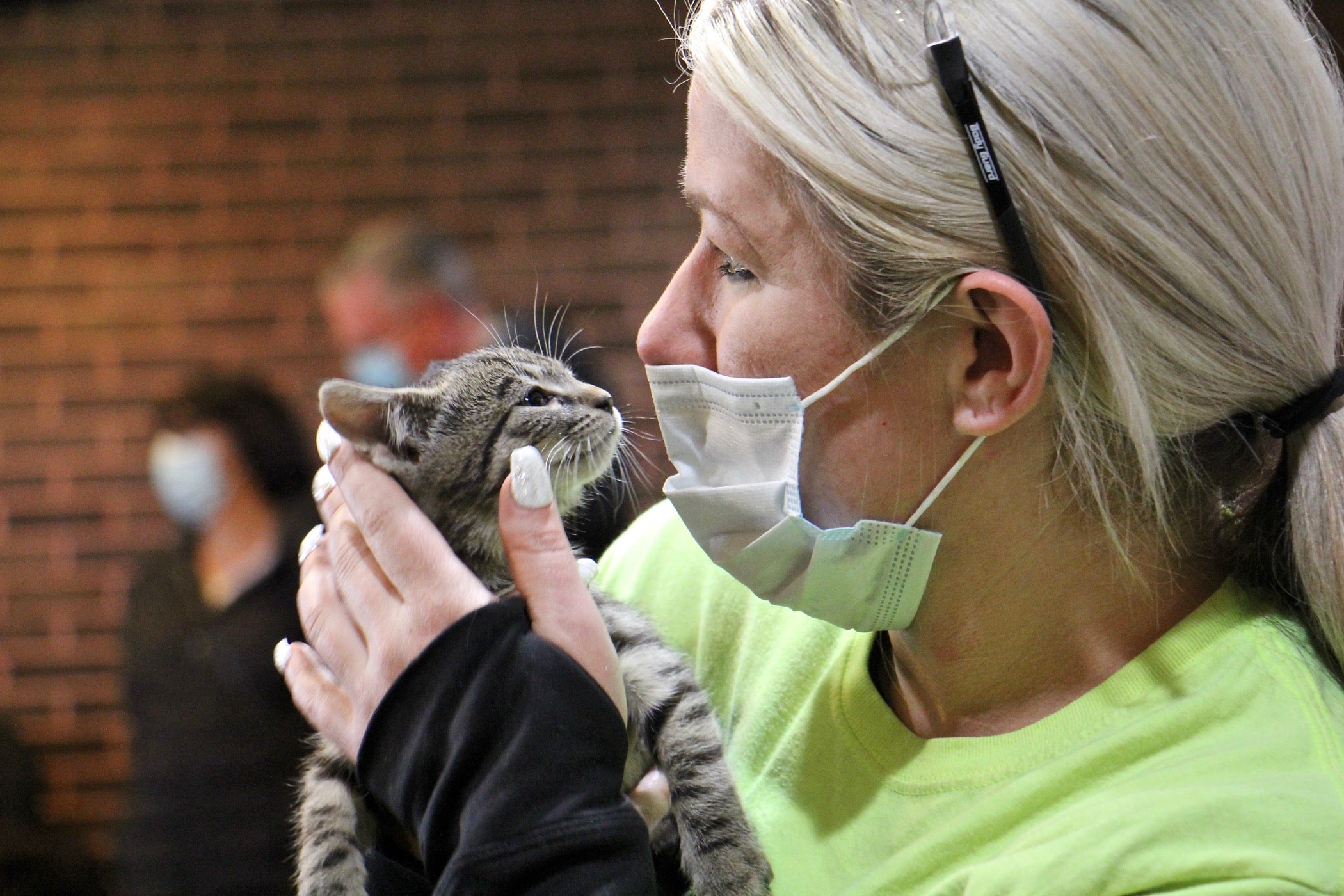 Ashley Bush (right), an employee at the Burlington County recycling plant in Westampton, holds Precious, the kitten she adopted