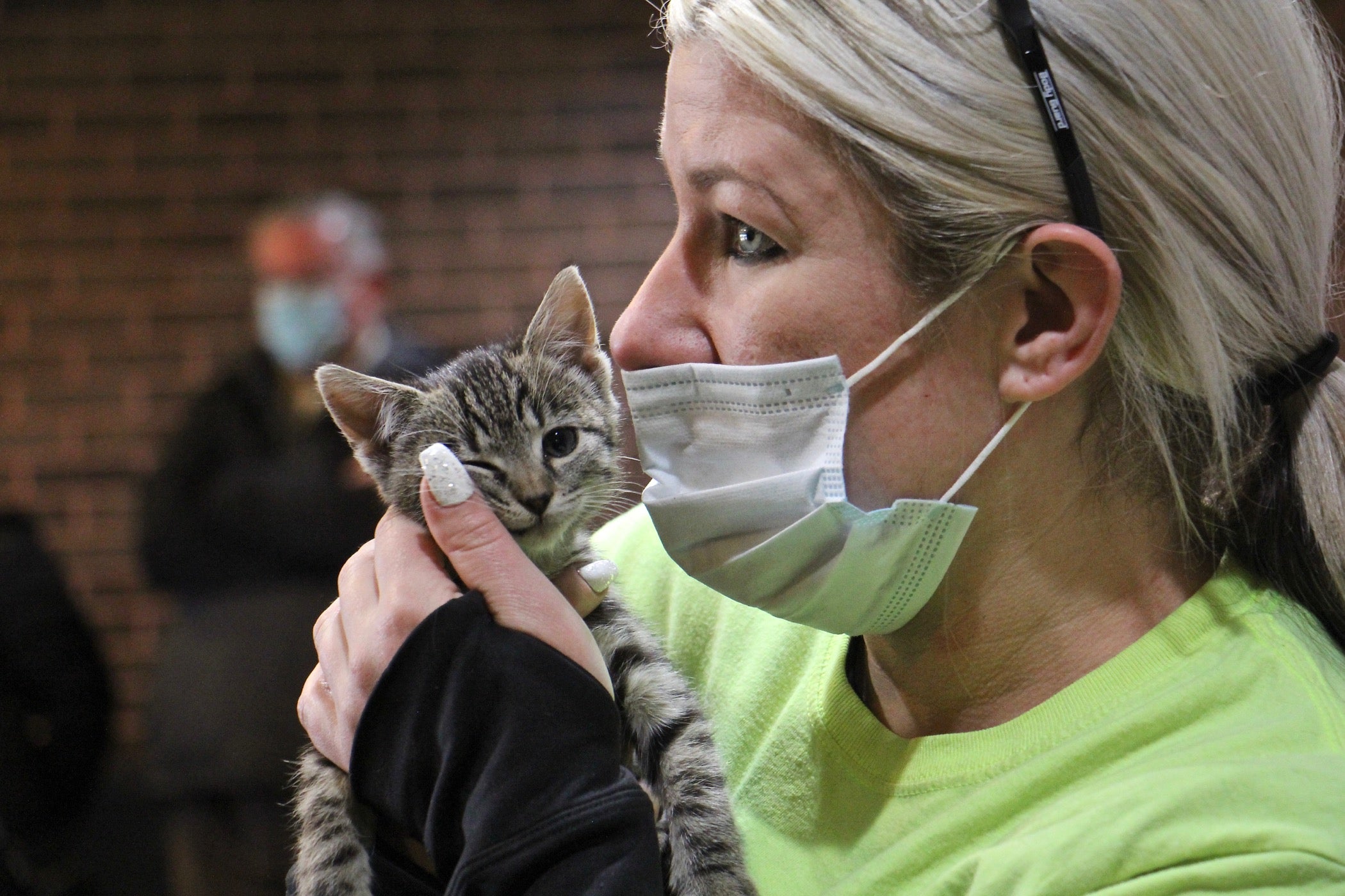 Ashley Bush (right), an employee at the Burlington County recycling plant in Westampton, holds Precious, the kitten she adopted