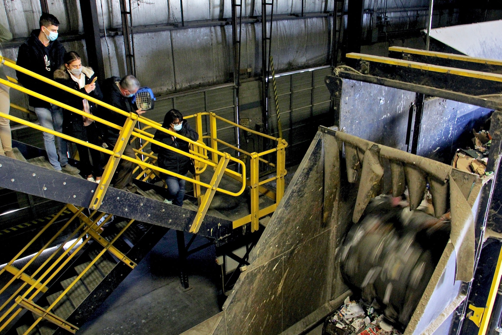 The Marshall family of Burlington Township, who adopted two of the kittens, watch the operation of the metering drum, designed to tear apart clumped recycling so it can be sorted