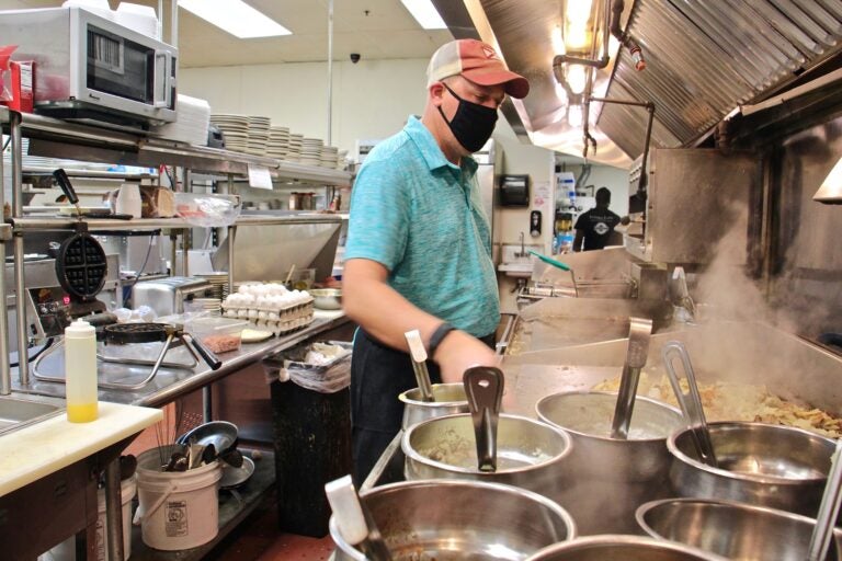 Mike Grafenstine works in the kitchen of his restaurant in Abington, Pa. (Emma Lee/WHYY)