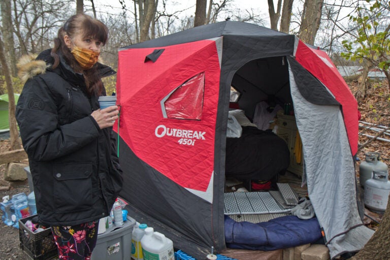 Dottie Spillane has been living near a creek in Norristown with her husband since the summer. She and her husband use a propane heater to heat their insulated tent as temperatures drop. (Kimberly Paynter/WHYY)