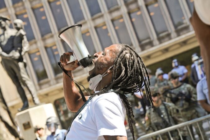 Hassan Bennett, who was wrongfully convicted of 2nd degree murder in 2006 and acquitted after acting as his own attorney and now works with the Defender Association of Philadelphia, joined protesters in front of the Roundhouse on June 8, 2020. (Kimberly Paynter/WHYY)