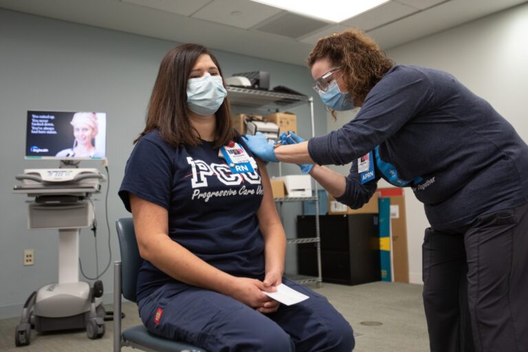 Bayhealth nurse Elisabeth Cote was vaccinated by co-worker Brittany Oakley