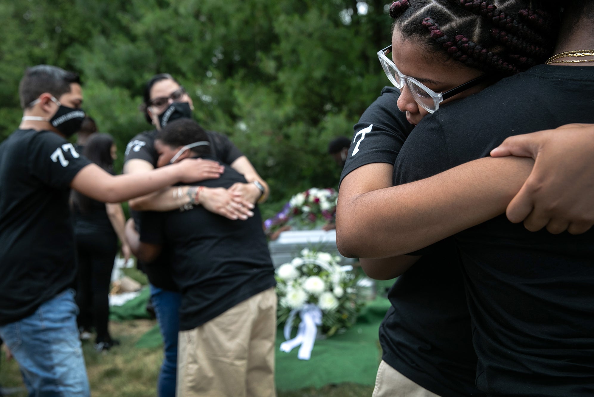 Family members mourn the death of Conrad Coleman Jr. at his burial