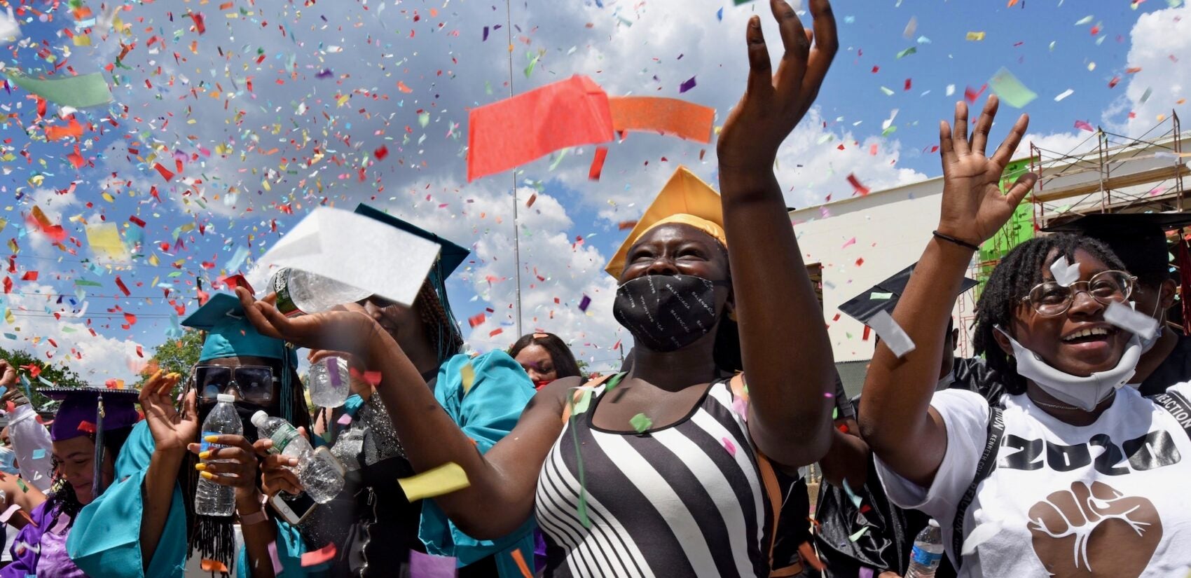 At Farnham Park on June 26, Camden High graduate Zanabria Harris, 18, stands in a sea of confetti at the end of the parade. (April Saul for WHYY)