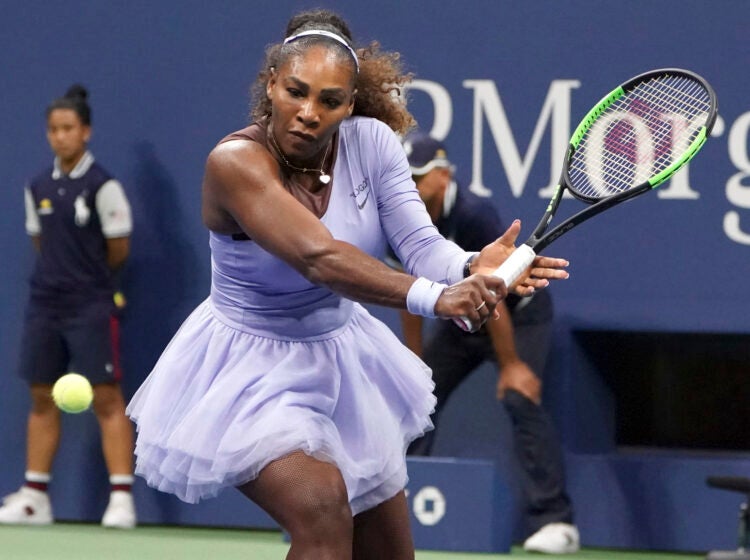 Serena Williams getting ready to hit a tennis ball