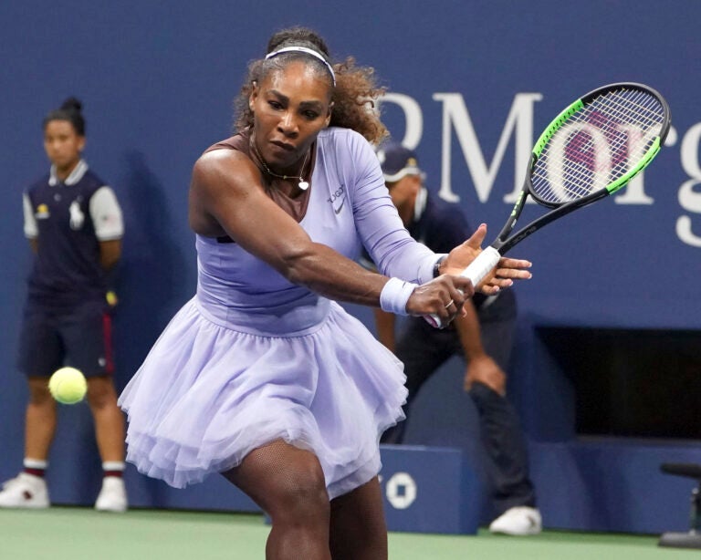 Serena Williams getting ready to hit a tennis ball