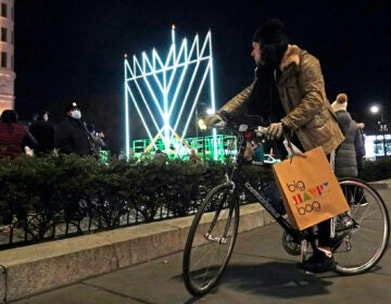 A man on a bicycle pauses on the sidewalk along Fifth Avenue in Manhattan near what has been described as 