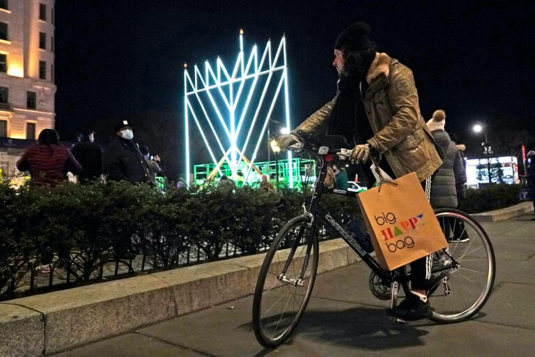 A man on a bicycle pauses on the sidewalk along Fifth Avenue in Manhattan near what has been described as 