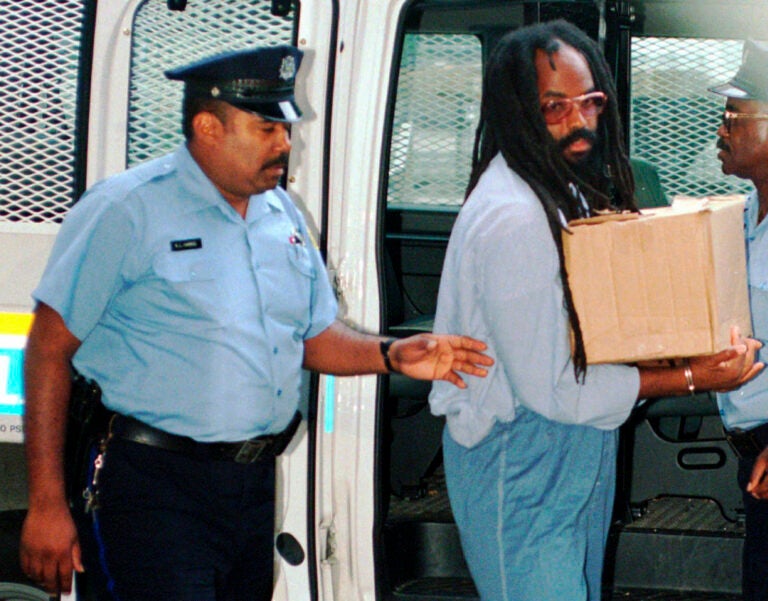 Mumia Abu-Jama is escorted by police in Philadelphia.