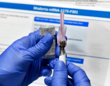 Nurse Kathe Olmstead prepares a shot as the world's biggest study of a possible COVID-19 vaccine, developed by the National Institutes of Health and Moderna Inc., gets underway Monday, July 27, 2020, in Binghamton, N.Y. (AP Photo/Hans Pennink)