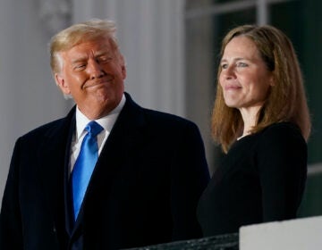 In this Monday, Oct. 26, 2020 file photo, President Donald Trump and Amy Coney Barrett stand on the Blue Room Balcony after Supreme Court Justice Clarence Thomas administered the Constitutional Oath to her on the South Lawn of the White House White House in Washington. (AP Photo/Patrick Semansky)