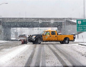 A snow plow drives across a road in a heavy snowfall in Morrisville, Pa. (AP Photo/Mel Evans)