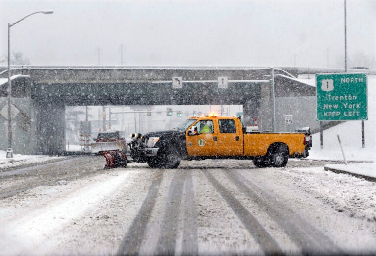 A snow plow drives across a road in a heavy snowfall in Morrisville, Pa. (AP Photo/Mel Evans)