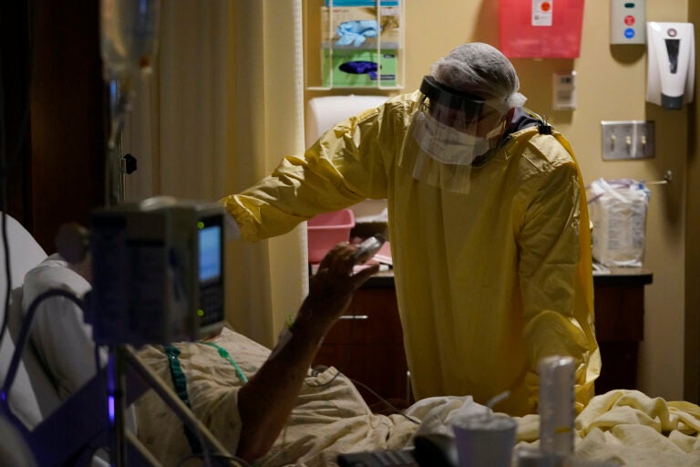 In this Nov. 24, 2020, file photo, Dr. Shane Wilson performs rounds in a portion of Scotland County Hospital set up to isolate and treat COVID-19 patients in Memphis, Mo.