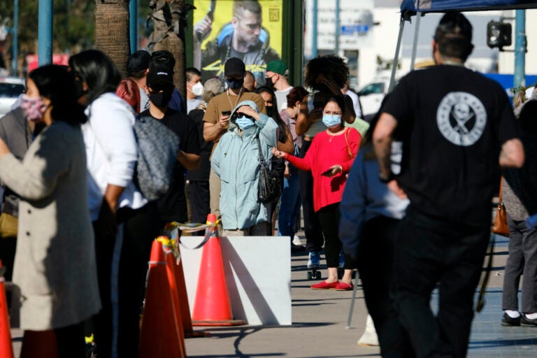 People wait in line to be tested for COVID-19 at a testing site in the North Hollywood section of Los Angeles