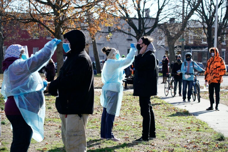 Registered nurses swab patients during testing for COVID-19 at Mifflin Square Park