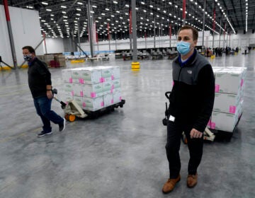 Boxes containing the Moderna COVID-19 vaccine are prepared to be shipped at the McKesson distribution center