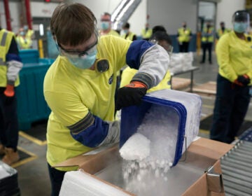 Dry ice is poured into a box containing the Pfizer-BioNTech COVID-19 vaccine as it is prepared to be shipped at the Pfizer Global Supply Kalamazoo manufacturing plant