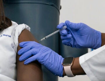 Sandra Lindsay, left, a nurse at Long Island Jewish Medical Center, is inoculated with the Pfizer-BioNTech COVID-19 vaccine by Dr. Michelle Chester