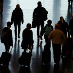 Travelers walk through the Salt Lake City International Airport