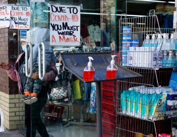 A sign warns patrons to wear a mask in the Ironbound section of Newark