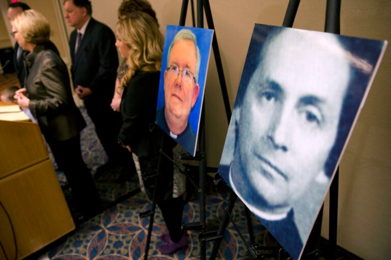 A photo of Rev. Robert Brennan, right, is displayed during a news conference in Philadelphia.