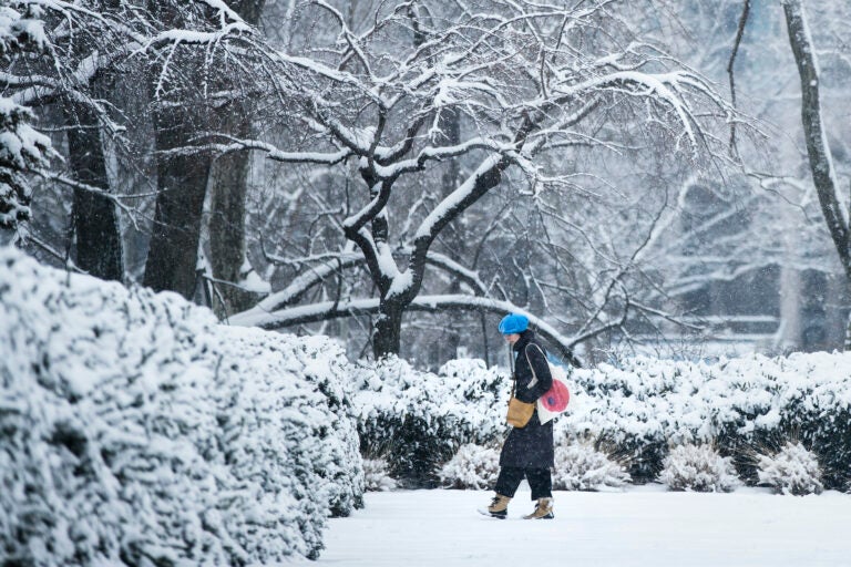 A woman walks in the snow at the Philadelphia Museum of Art in Philadelphia