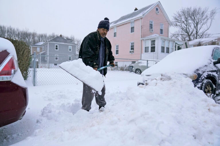 Barry James digs out his car, as well as his daughter’s car, before trying to get to work in Englewood