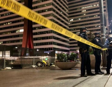 Police stand by the Clothespin Sculpture near City Hall, where a dirt bike rider was fatally shot on Nov. 16, 2020.