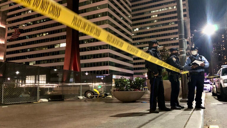 Police stand by the Clothespin Sculpture near City Hall, where a dirt bike rider was fatally shot on Nov. 16, 2020.