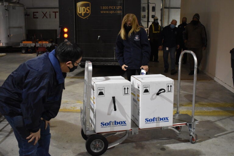 At right, Dr. Karyl Rattay, Delaware's public health director, checks out the arrival of COVID-19 vaccination doses on Wednesday. (State of Delaware)