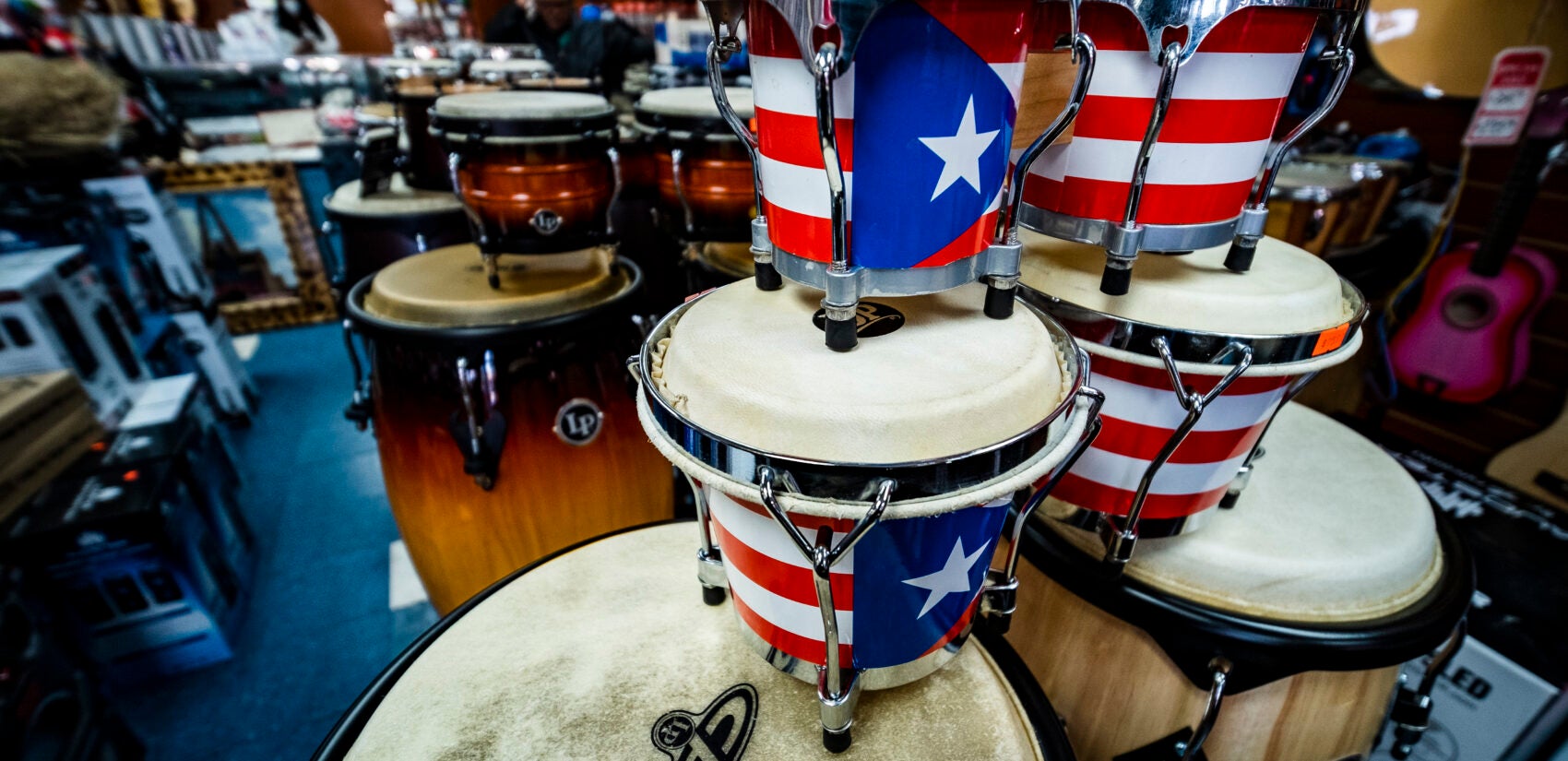 Bongos and congas adorned with the Puerto Rican flag. | Bongos y congas adornados con la bandera puertorriqueña. (Photo by Bernardo Morillo for WHYY)