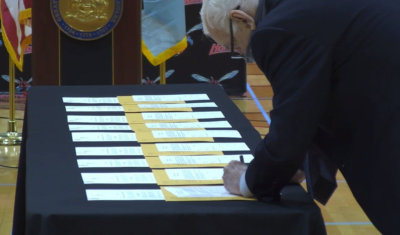 Elector John Daniello casts his ballot for Joe Biden and Kamala Harris during a ceremony at Delaware State University in Dover. 