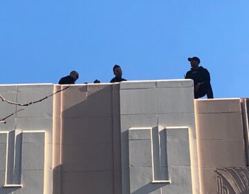 Counter-snipers take up posts atop The Queen theater and the neighboring Delaware History Museum in downtown Wilmington when Biden is there. (Cris Barrish/WHYY)