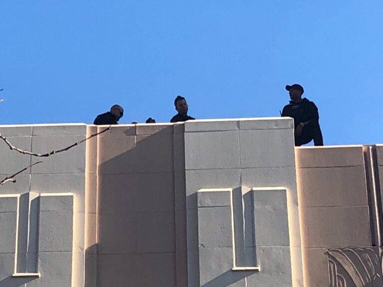 Counter-snipers take up posts atop The Queen theater and the neighboring Delaware History Museum in downtown Wilmington when Biden is there. (Cris Barrish/WHYY)