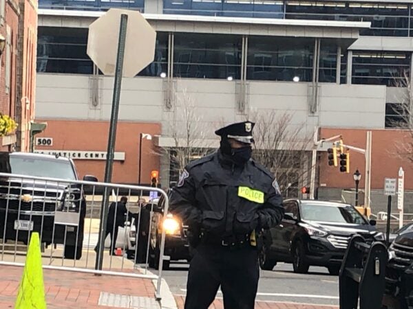 A Wilmington police officer stands guard outside The Queen. (Cris Barrish/WHYY)